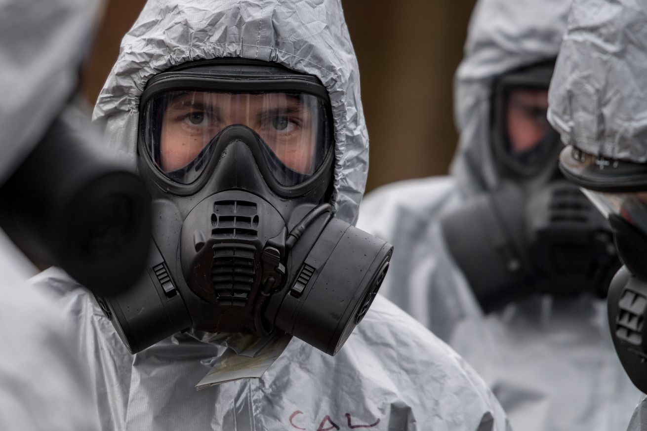 Military personnel in gas masks investigated the Skripal’s poisoning in March. 