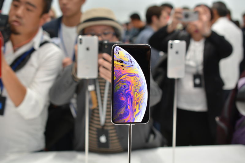 Smartphones on display at a crowded convention.