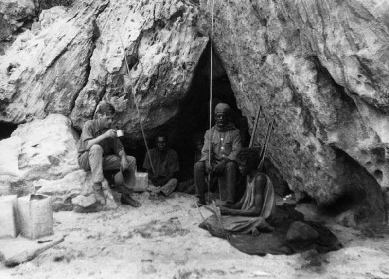 Norman Tindale, pictured here in 1927 with members of a local Aboriginal group, led a mission to gather precise ethnographic and geographic data from many different Aboriginal groups. He also gathered hair from the people he interviewed, which provided DNA samples for earlier studies. The group here is at Rockshelter at Bathurst Head (Thartali) in eastern Cape York Peninsula. 