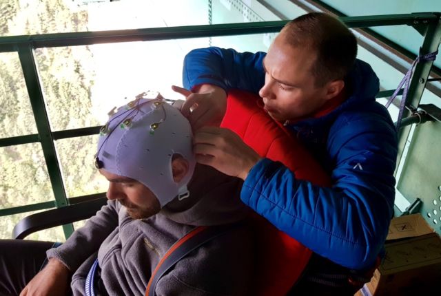 The study's first author, Marius Nann, prepares the electrode cap which will be used to record the bungee jumper's brain activity.