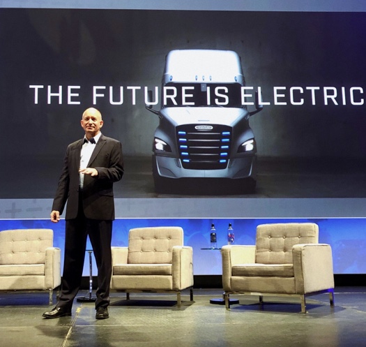 Roger Nielsen, president and CEO of Daimler Trucks North America standing on a stage.