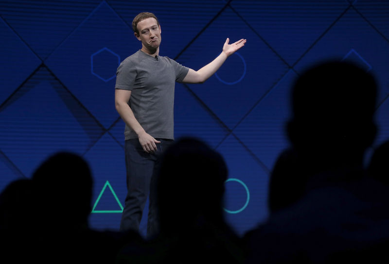 Mark Zuckerberg shrugs while addressing listeners at an event.