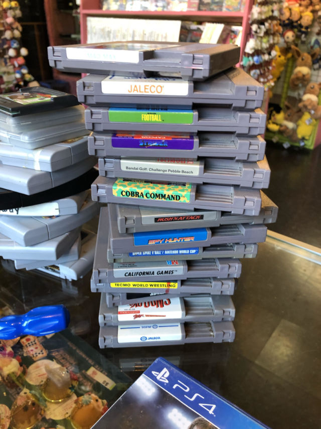 The most recently discovered Nintendo World Championship cartridge was buried in a brown paper sack, beneath this pile of unremarkable, unboxed NES fare.