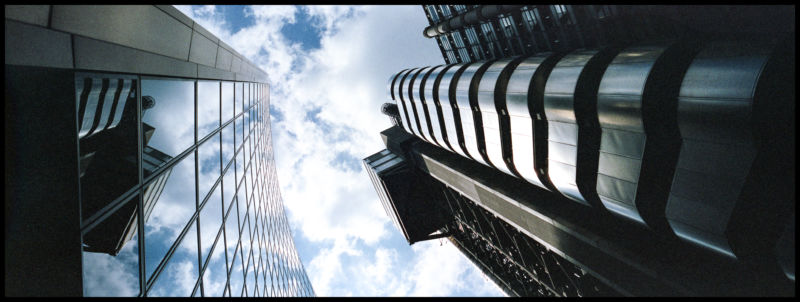 Glass-walled skyscraper photographed from below.