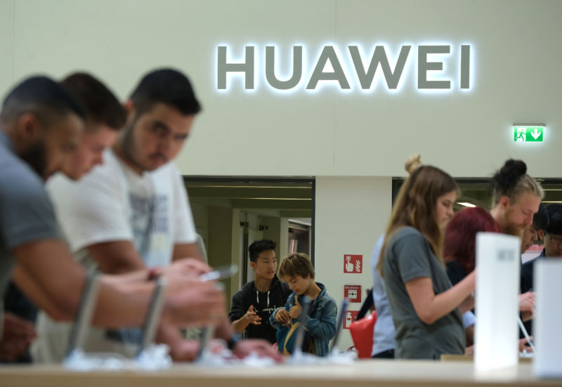 Visitors check out new Huawei smartphones at the 2019 IFA home electronics and appliances trade fair Berlin.