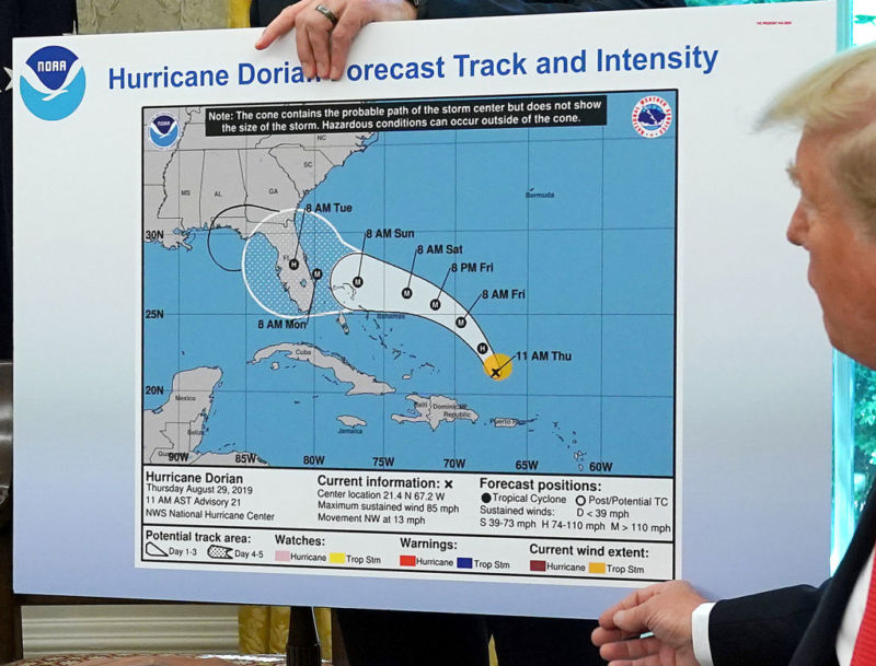 President Donald Trump displaying a doctored forecast map that incorrectly shows Hurricane Dorian hitting Alabama.