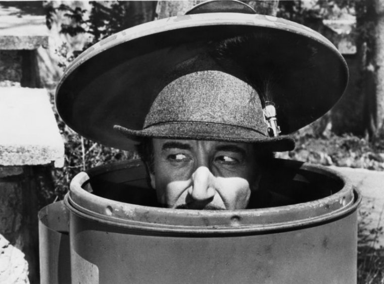 Peter Sellers as Inspector Clouseau is disguised as a mountain climber, while hiding in a trash can, in a scene from the film 'The Pink Panther Strikes Again', 1976. (Photo by United Artists/Getty Images)