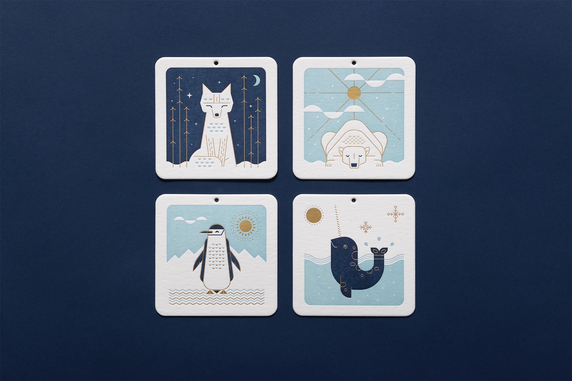 Typically cold-weather creatures on coasters that double as ornaments: fox, polar bear, penguin and narwhal