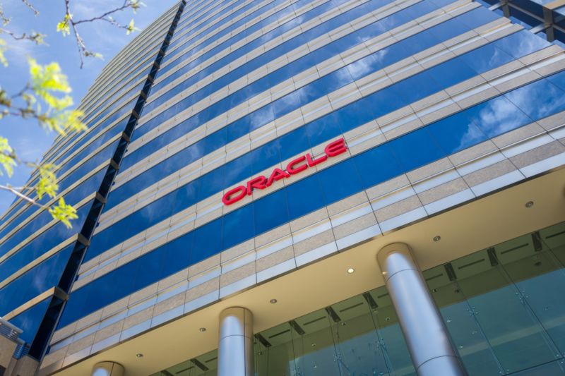 Glass skyscraper with Oracle logo on front.