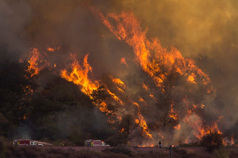 Flames spread up a hillside near firefighters at the Blue Cut Fire on August 18, 2016 near Wrightwood, California. 