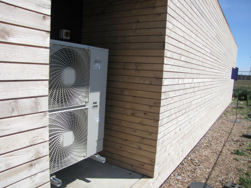 An air source heat pump nestled in a nook.