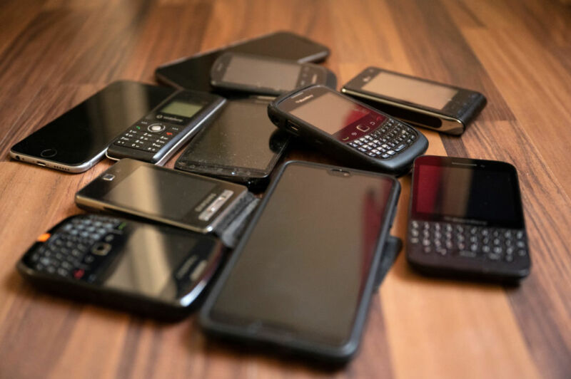 Unused mobile phones lie on the floor.