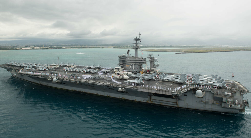 The aircraft carrier USS <em>Theodore Roosevelt</em> arriving at Pearl Harbor in 2018.