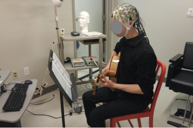 A jazz guitar player improvising while his brain activity (EEG) is recorded.