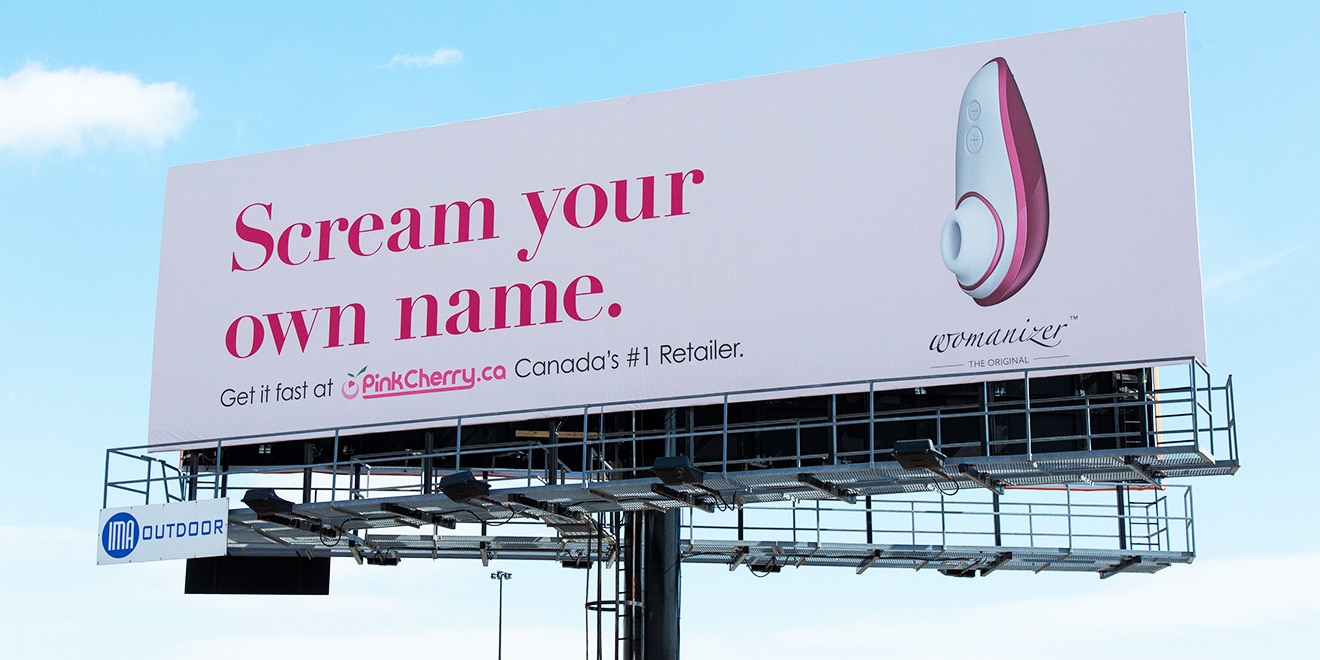 A Canadian sex toy ad is displayed on a billboard facing a popular highway.