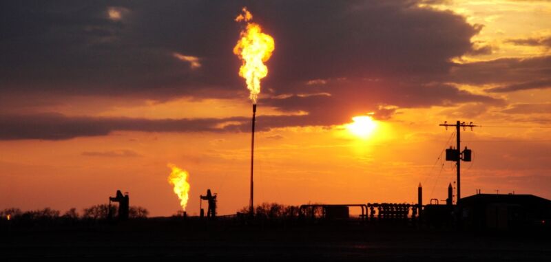 Image of fossil fuel wells and the flames powered by vented gasses.