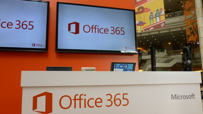 The Office Three 65 logo is emblazoned on TVs and boxes in a shopping mall.