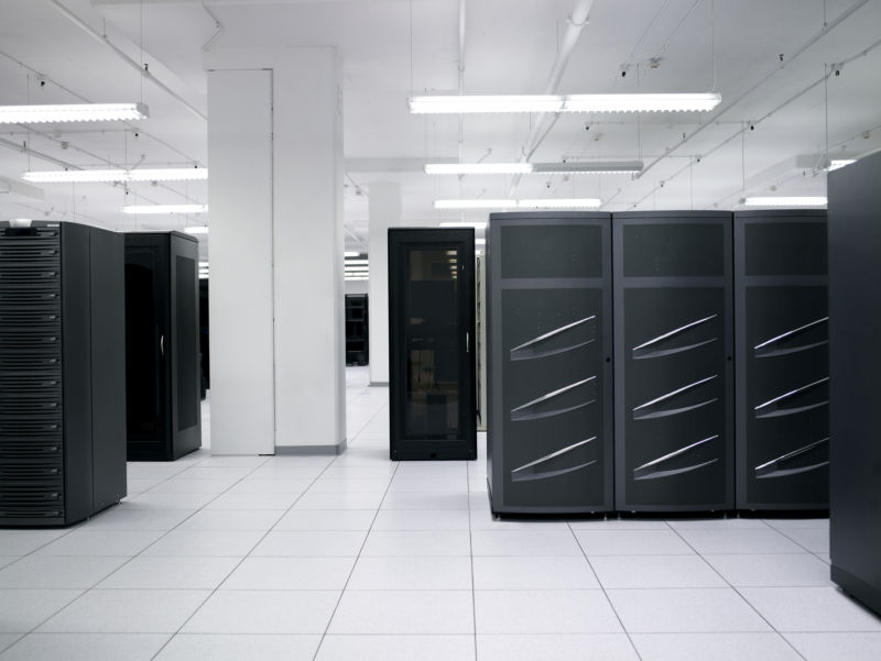 A data center stock photo. I spy with my little eye some de-badged EMC Symmetrix DMX-3 or DMX-4 disk bays at right and some de-badged EMC CX disk bays at left. Disk arrays like these are a mainstay of traditional enterprise data center SANs.