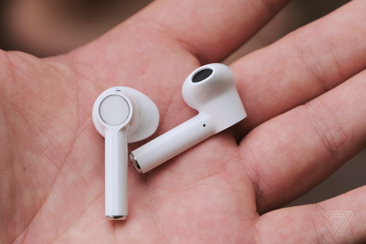 A close-up photo of the OnePlus earbuds in a person’s hand.