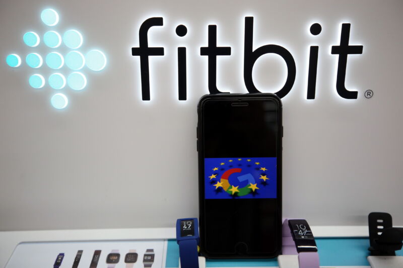 Logo of Google is displayed on a smartphone by logo of Fitbit in Brussels, Belgium on August 4, 2020. 