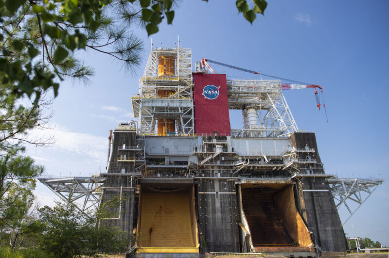 The Space Launch System rocket core stage is shown installed on the top-left side of the B-2 Test Stand at NASA’s Stennis Space Center.