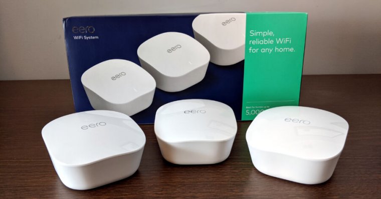 White electronic devices in a row on a table.