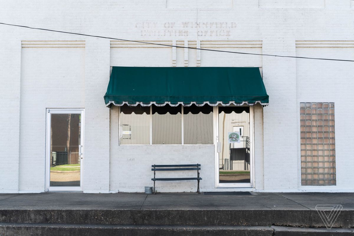 A storefront in downtown Winnfield, Louisiana where traces of removed lettering for the City of Winnfield Utilities Office can be seen above the door.