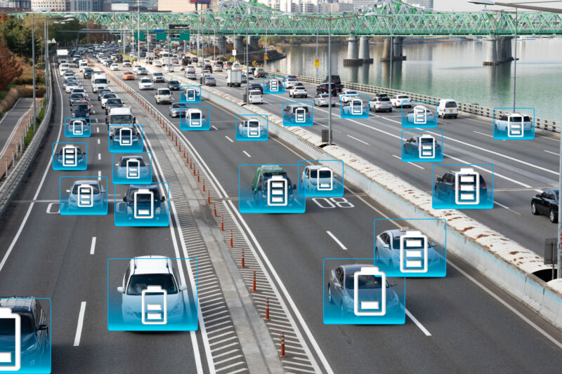 Electric battery readouts have been superimposed over cars driving down a highway.