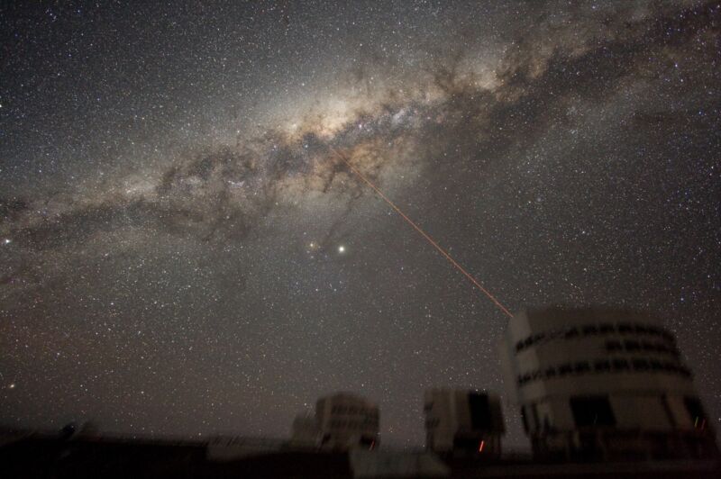 Image of the night sky above Paranal, Chile, on July 21, 2007, showing the galactic center of the Milky Way. The laser creates a guide-star for the telescope. 