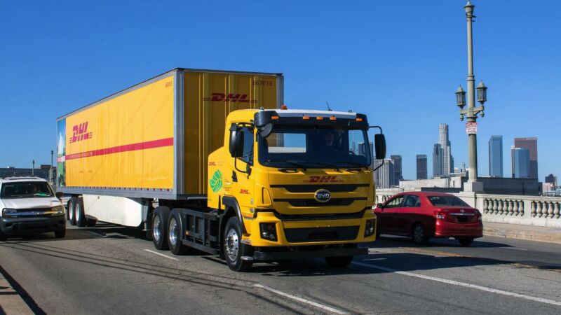 An electric DHL class 8 truck on a bridge in Los Angeles