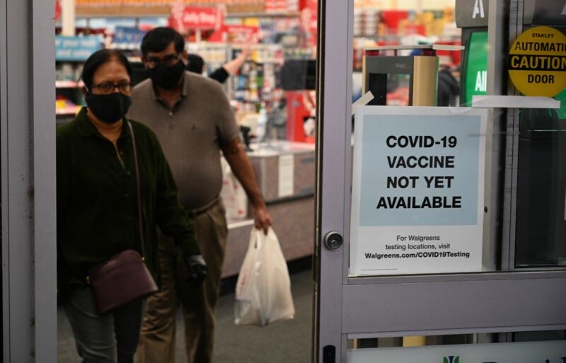 A sign on the entrance to a pharmacy reads "Covid-19 Vaccine Not Yet Available," November 23, 2020 in Burbank, California. 