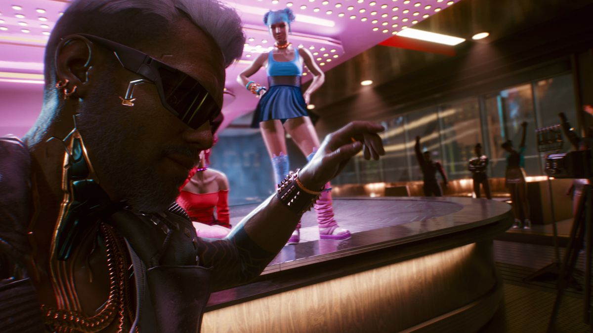 Jackie, your partner in Cyberpunk 2077, in front of a table dancer at a nightclub.