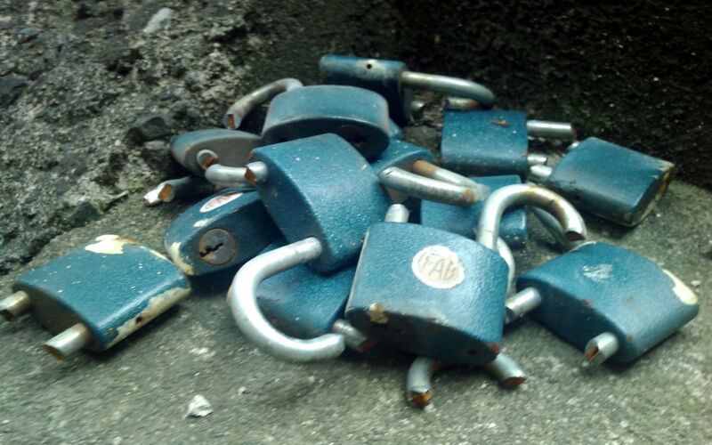 Broken padlocks piled in a corner.