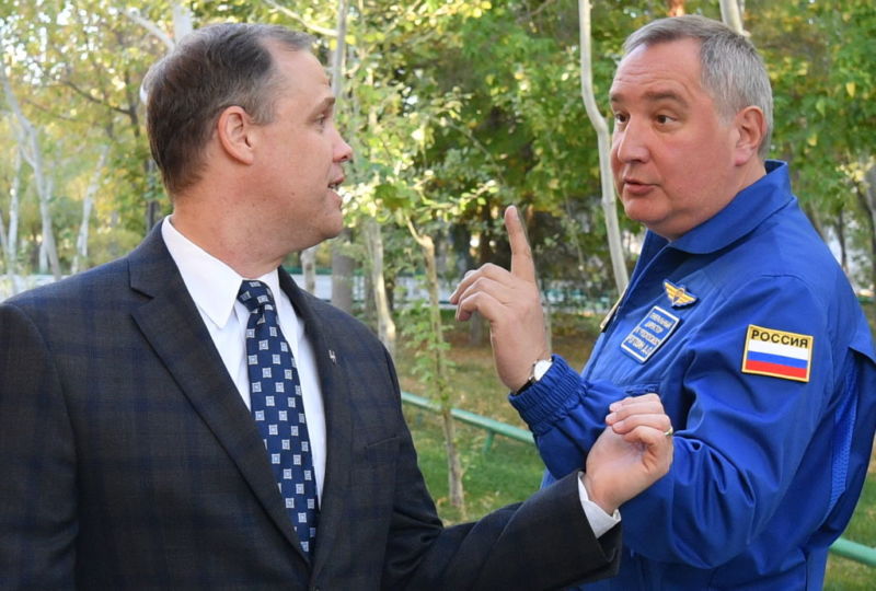 NASA Administrator Jim Bridenstine, left, speaks with Roscosmos' Dmitry Rogozin in 2019.