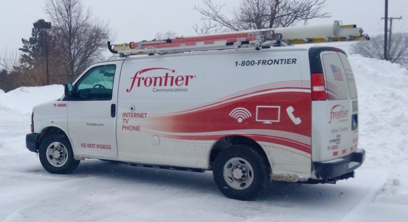 A Frontier Communications service van parked in a snowy area.