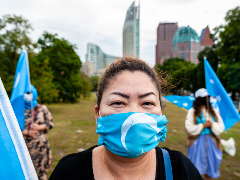 A woman is wearing a mask with the Uighur flag on it during the demonstration 'Freedom for Uyghurs' in The Hague, Netherlands on August 20, 2020.