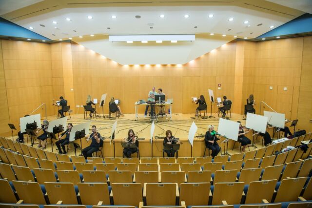 Sixteen violinists participated in a networking experiment in which they were connected to a computer system, hearing only the sound received from the computer.