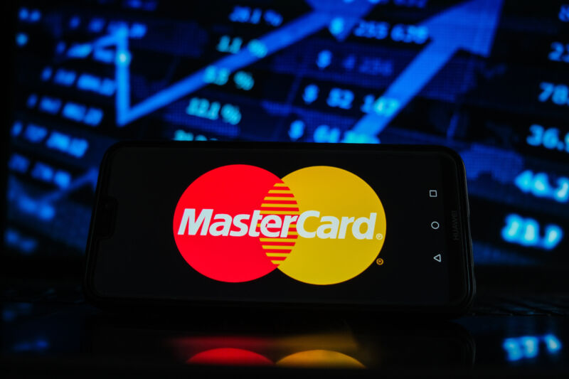 In this photo illustration a Mastercard logo seen displayed