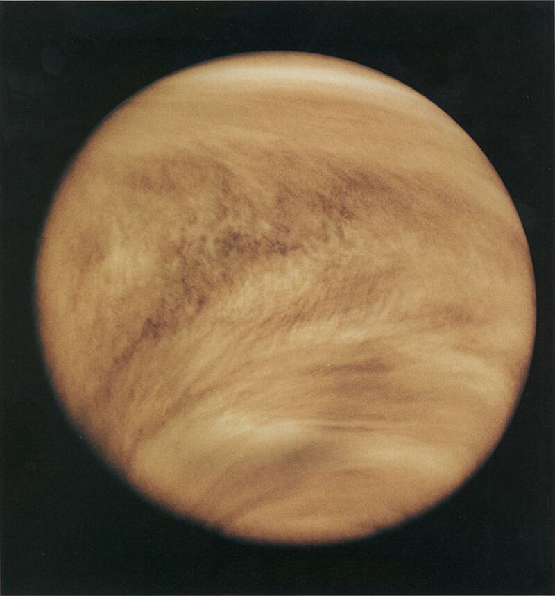 Image of a yellow-brown planet.