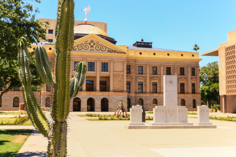 A cactus-flanked building combines neoclassical and hacienda architecture.