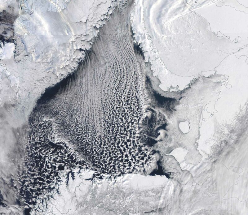 Image of clouds streaming over the ocean.