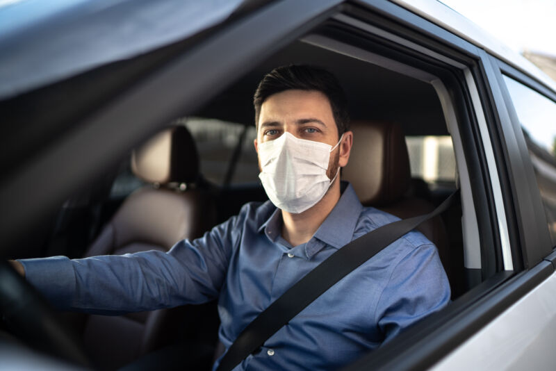 Portrait of driver wearing protective medical mask