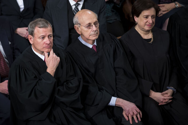 Supreme Court Justices John Roberts, Stephen Breyer, and Elena Kagan sitting and listening to a State of the Union address in Congress.