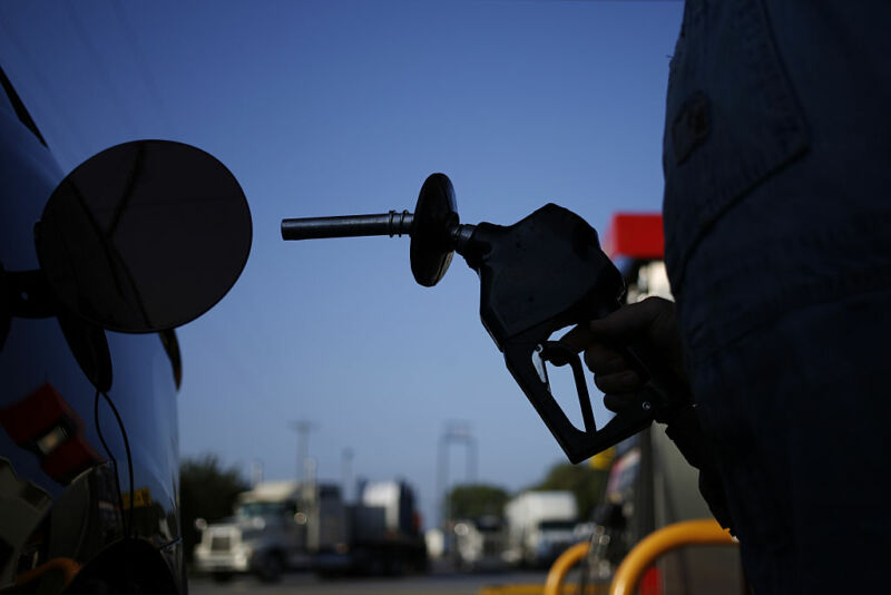 Problems with Colonial Pipeline's distribution system tend to lead to gasoline runs and price increases across the US Southeast and Eastern seaboard. In this September 2016 photo, a man prepared to refuel his vehicle after a Colonial leak in Alabama.