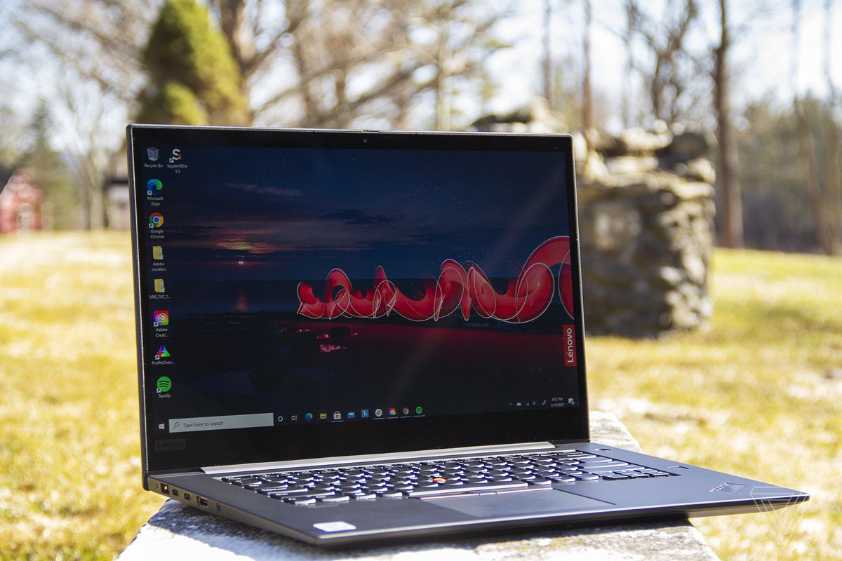 Lenovo Thinkpad X1 Extreme Gen 3 angled slightly to the right, open. The screen displays an outdoor nighttime scene with the Lenovo logo on the right.