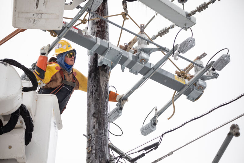 A worker repairs a power line in Austin, Texas, on Thursday, Feb. 18, 2021.