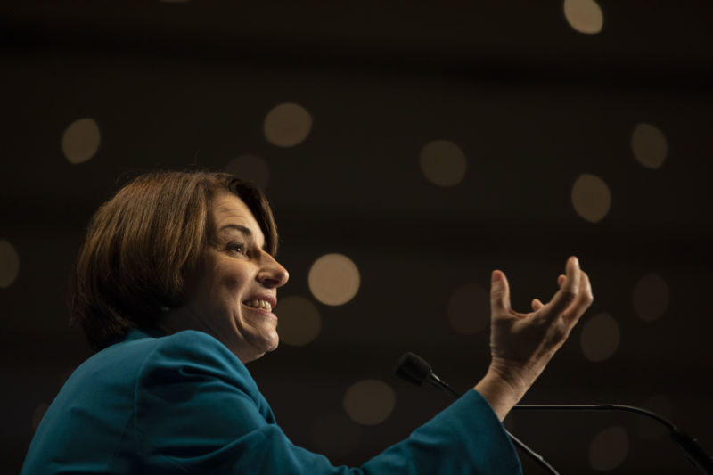 A woman gestures during a presentation.