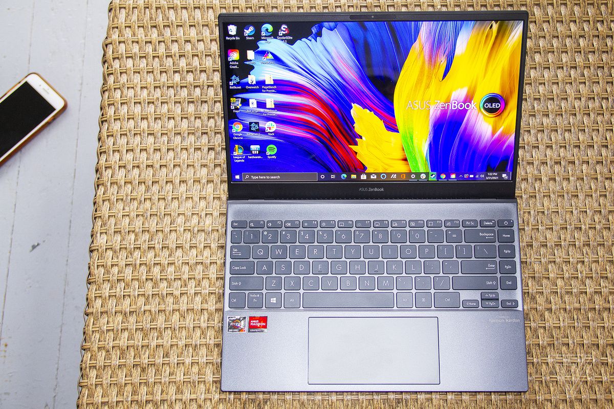 The Asus Zenbook 13 OELD seen from above. The screen displays Zenbook and OLED logos on a multicolor background.