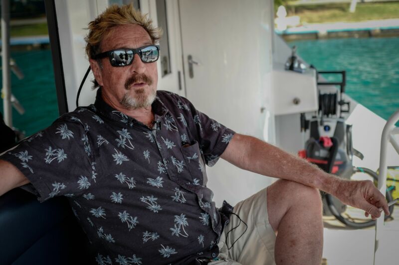 A casually dressed and sunweathered man reclines with a cigarette on a yacht.