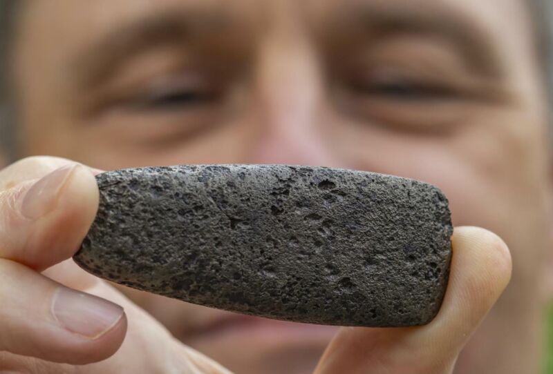 Florida Museum archaeologist Charles Cobb holds an axe head known as a celt, one of more than 80 metal objects likely from the de Soto expedition. To create this distinct shape, a Chickasaw craftsperson reworked Spanish iron to mimic traditional stone versions.